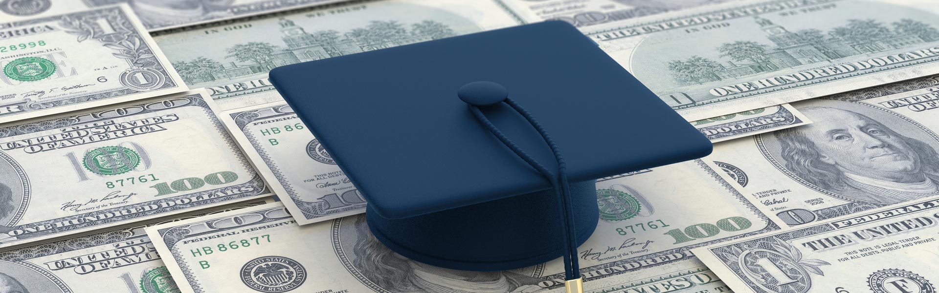 Graduation hat on top of dollar bills