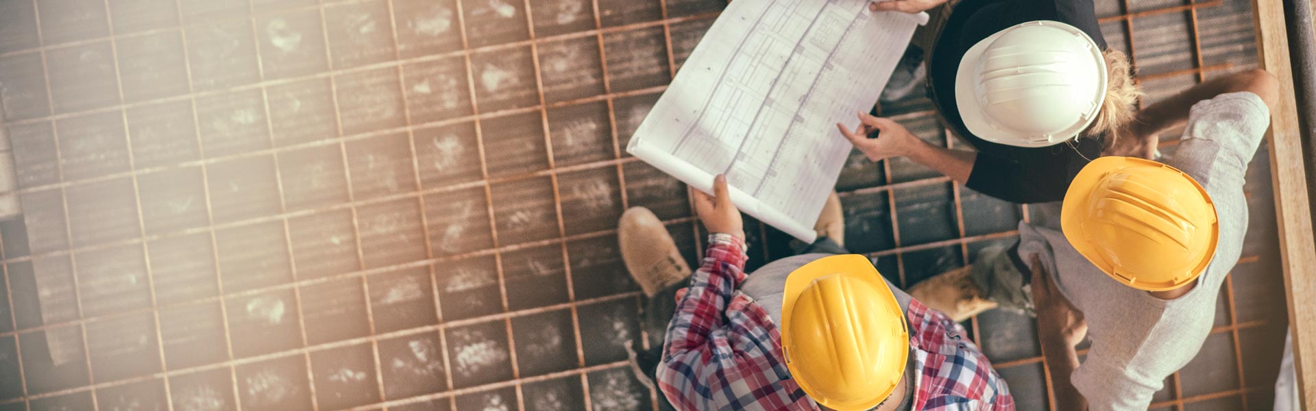 Architect and construction workers looking at blueprint