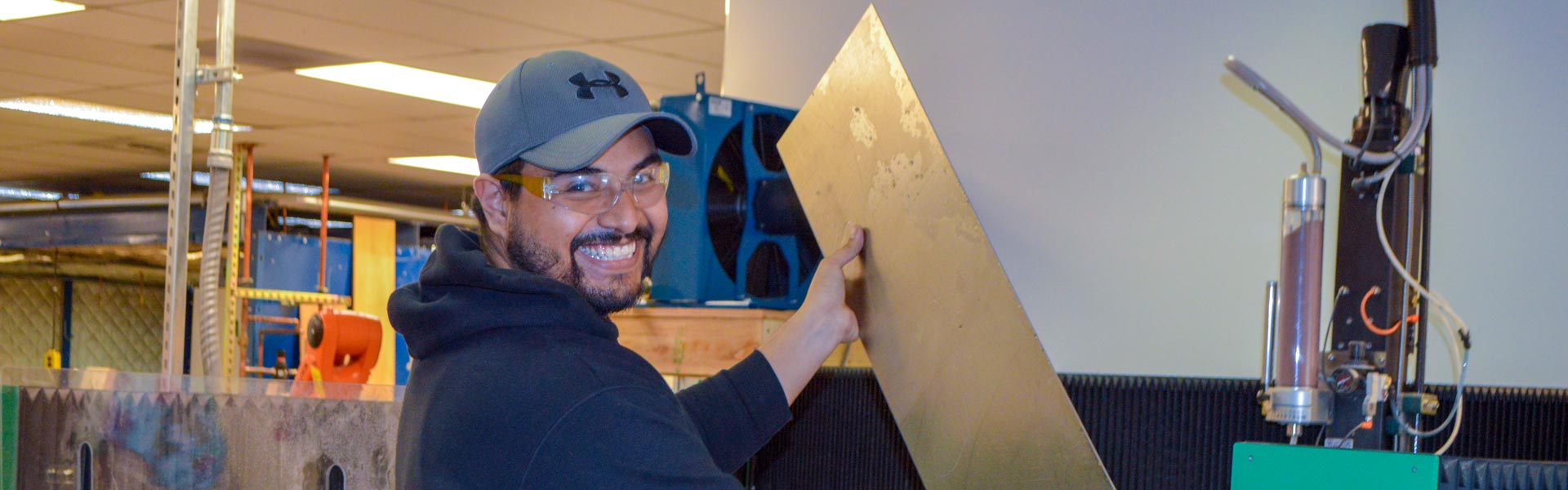 Engineering technology student at a waterjet