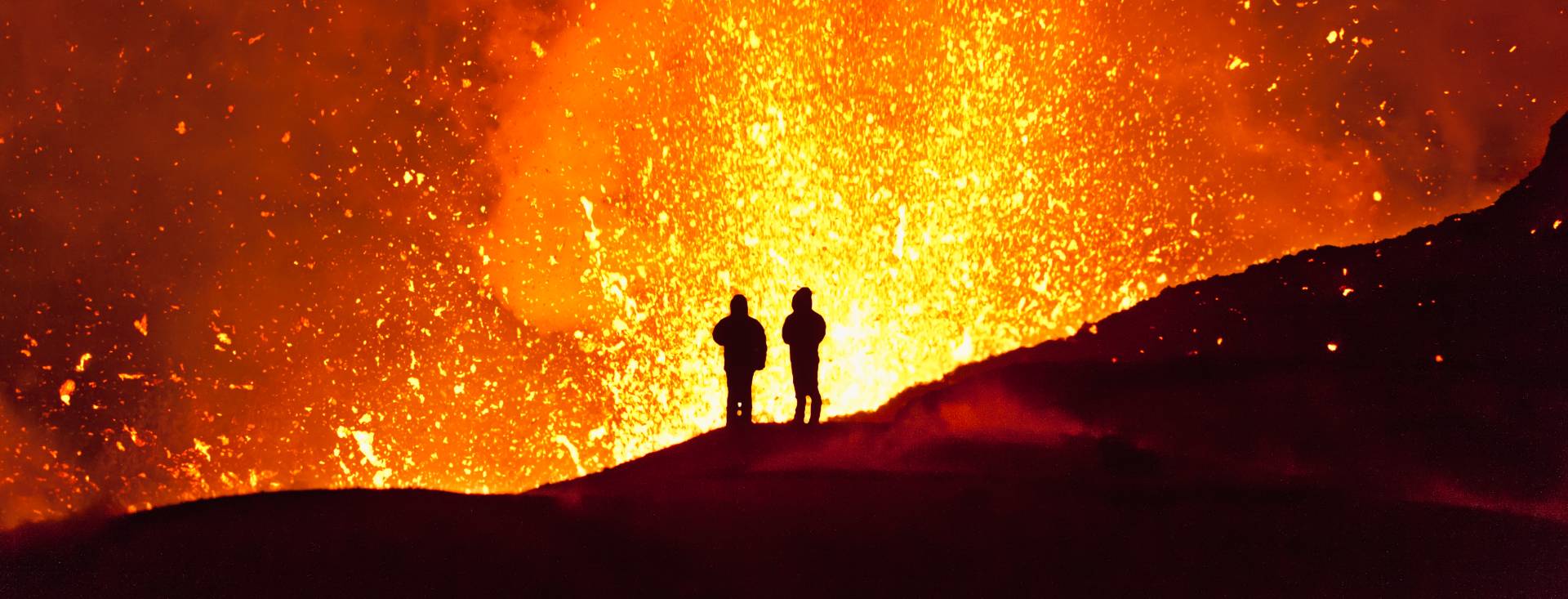 People near an erupting volcano