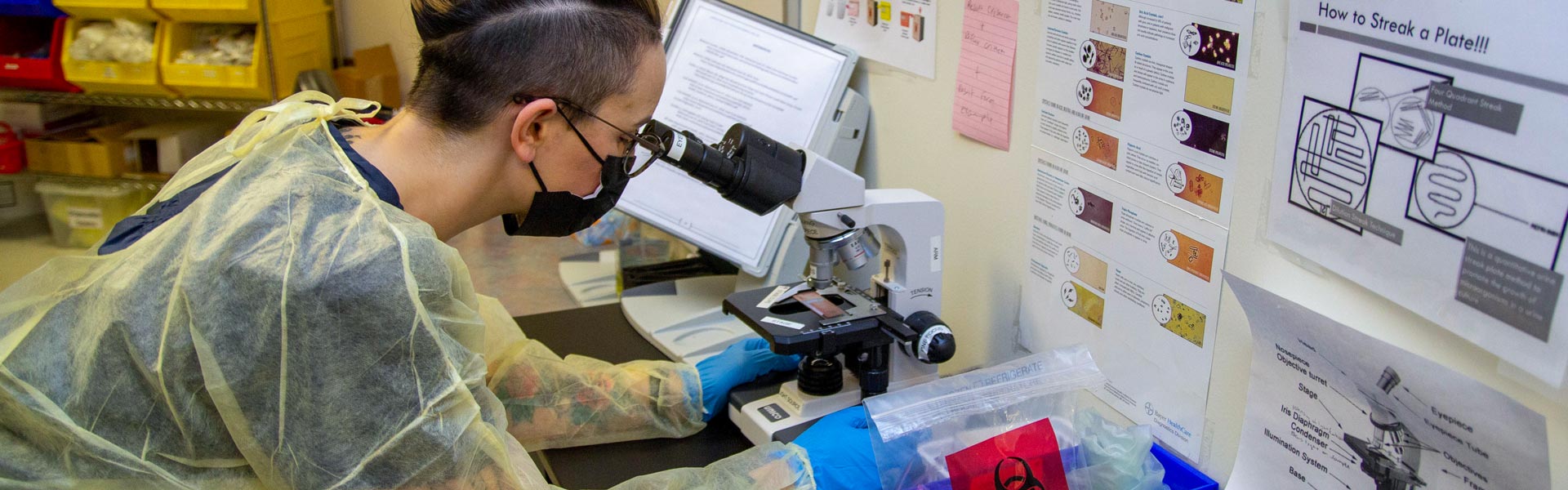 Allied Health Student looking through a microscope