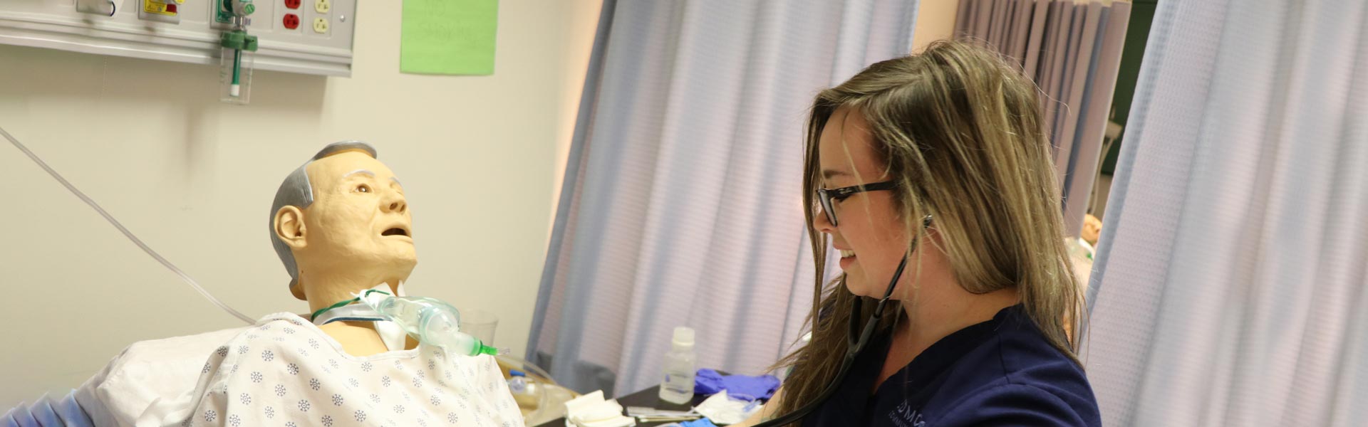 Nursing student with mannequin