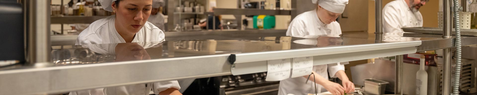 Culinary Arts Students working with instructor in the kitchen