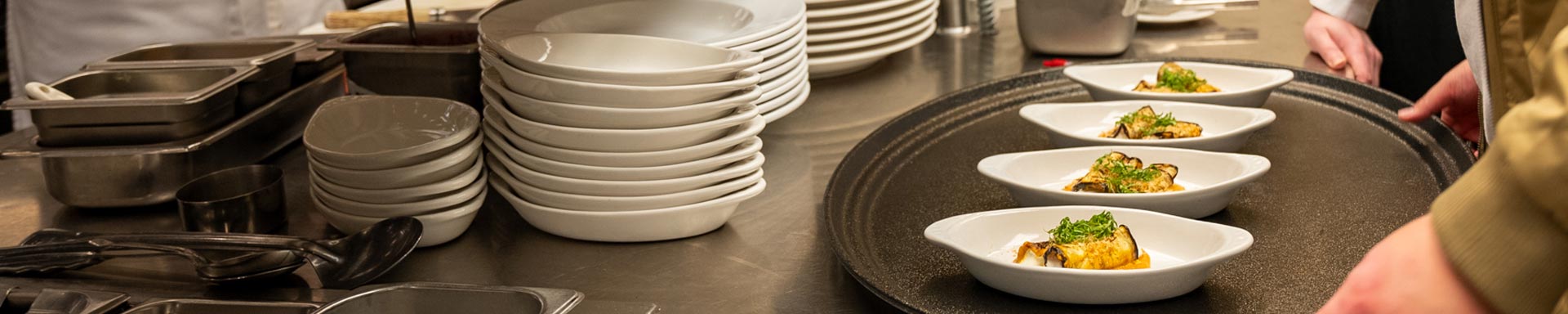 Culinary Arts Students working with instructor in the kitchen