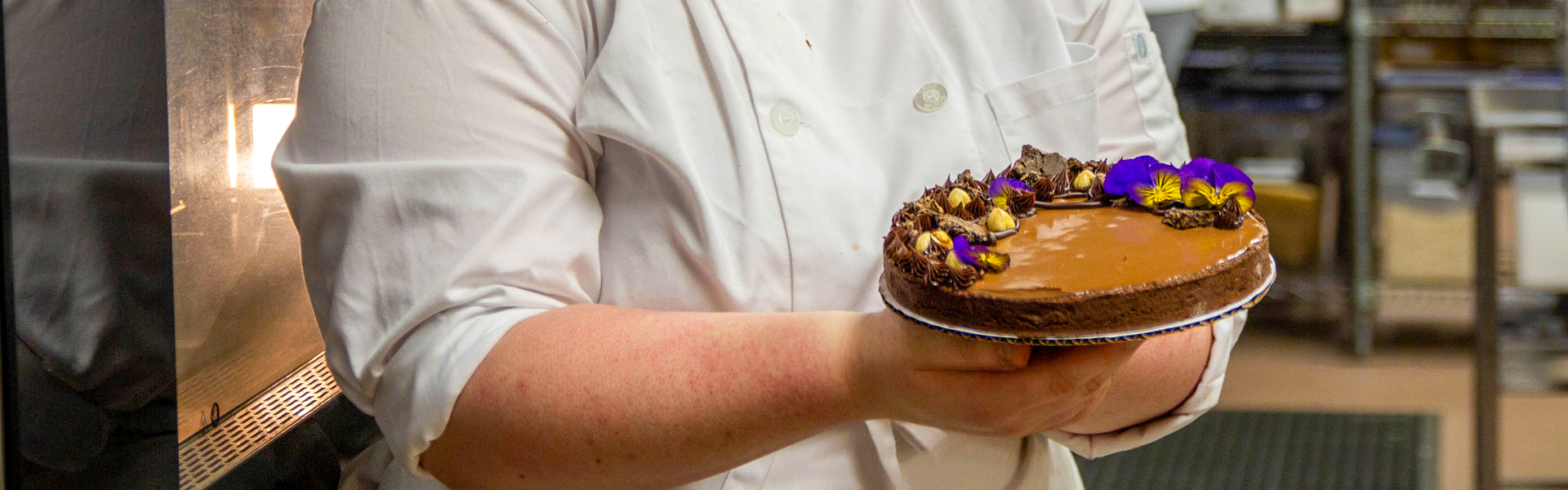 Culinary Art student holding a cake