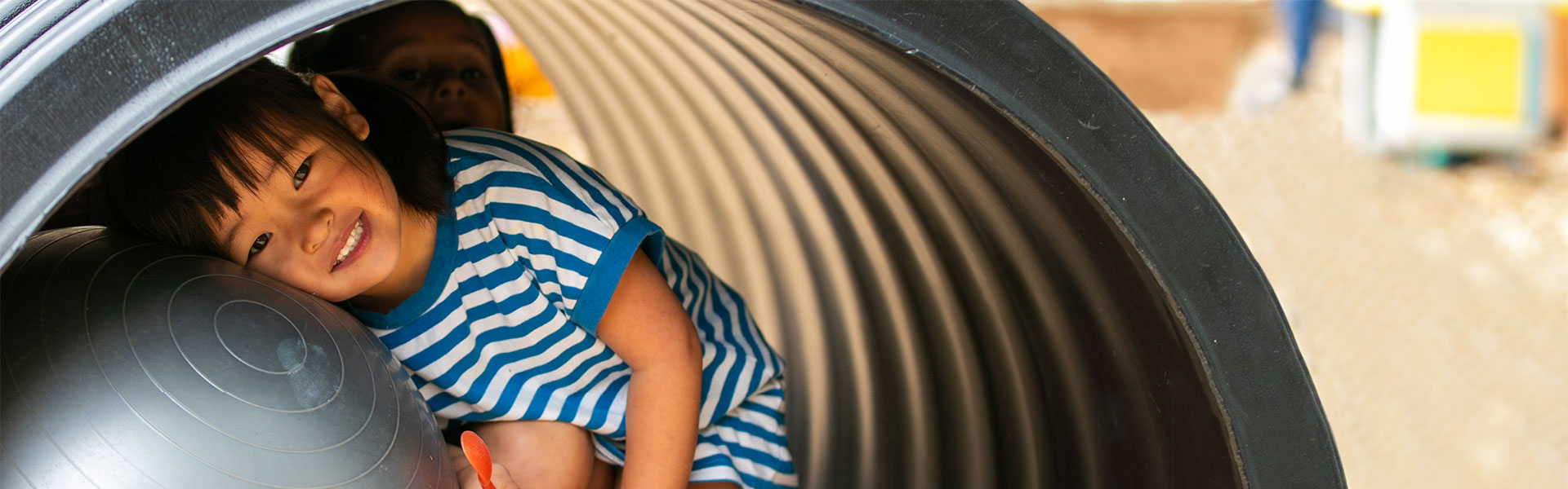 Child plays in a tunnel at the Edmonds College Center for Families