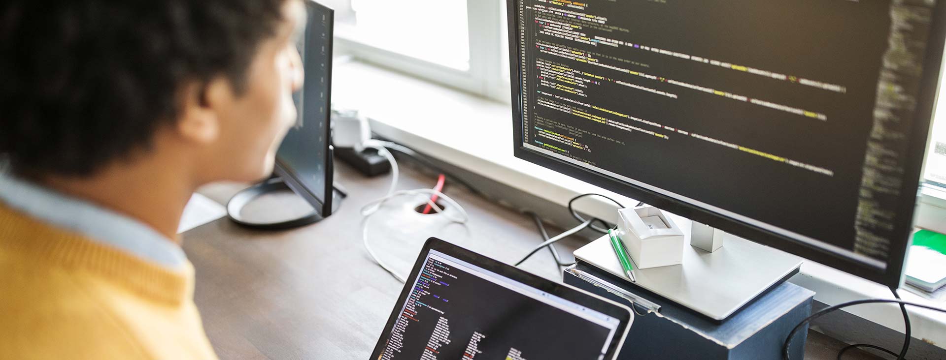 Man looking at computer code