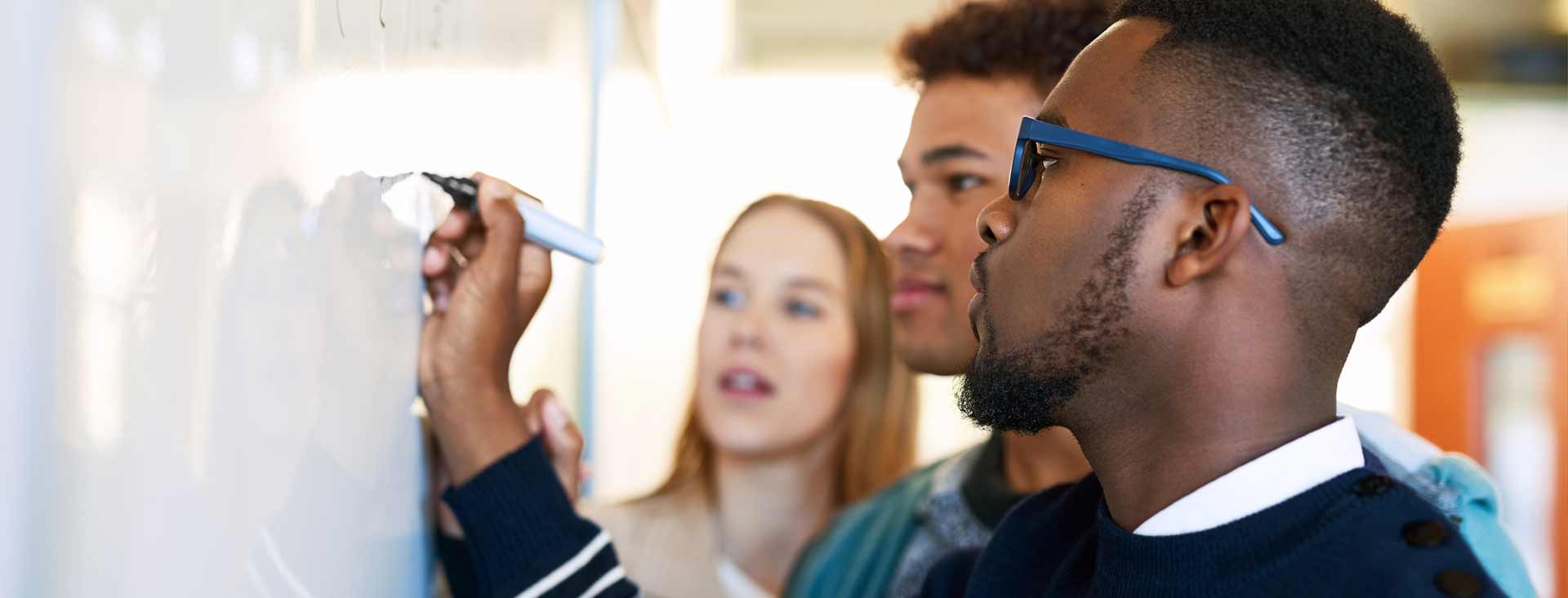 Students working on math problem on a board