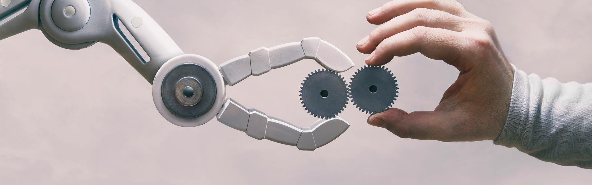 Human and Robot hands holding gears