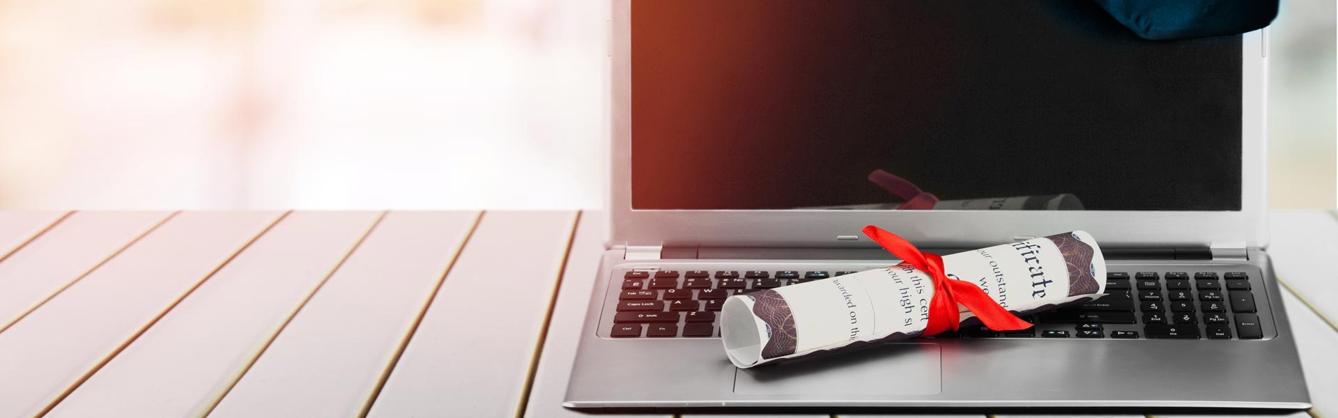 Laptop with diploma scroll