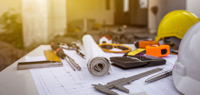 Hardhat, tools, and building plans