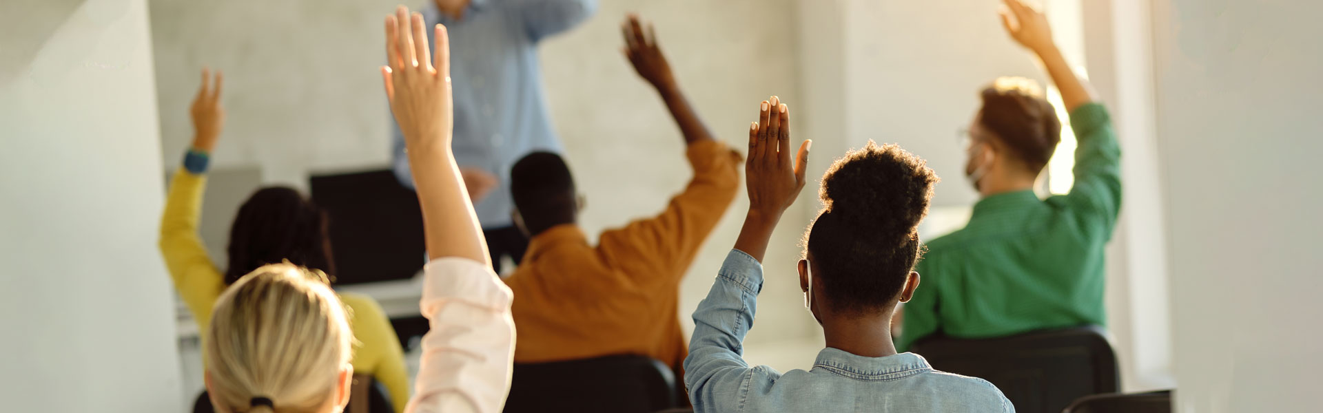 Students raisong hands in class